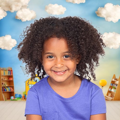 Beautiful Afroamerican little  girl with a blue t-shirt isolated on a white background